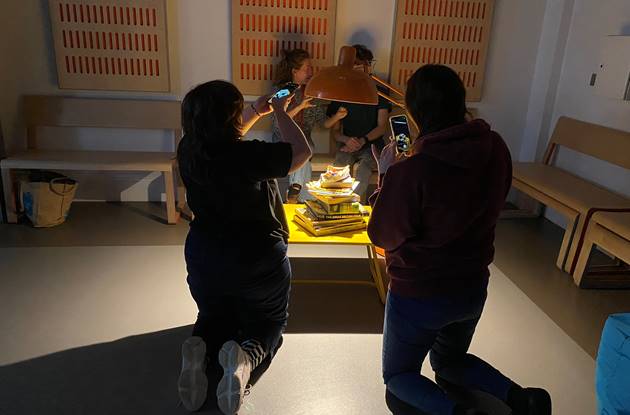 Young people photographing objects as part of task